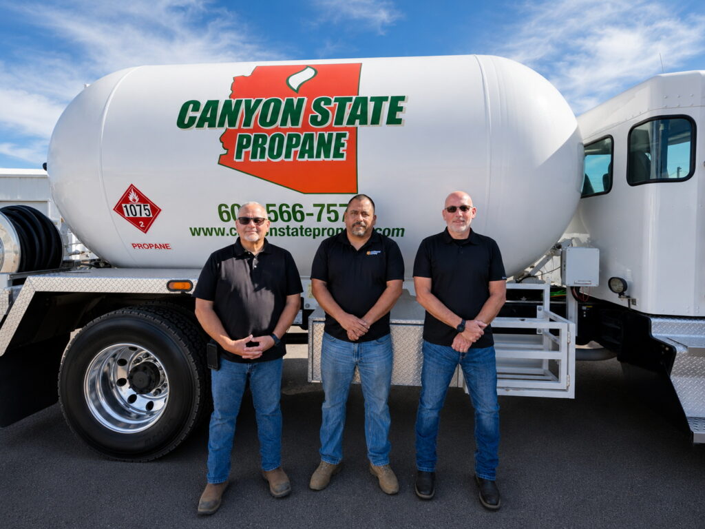 team members standing in front on propane truck