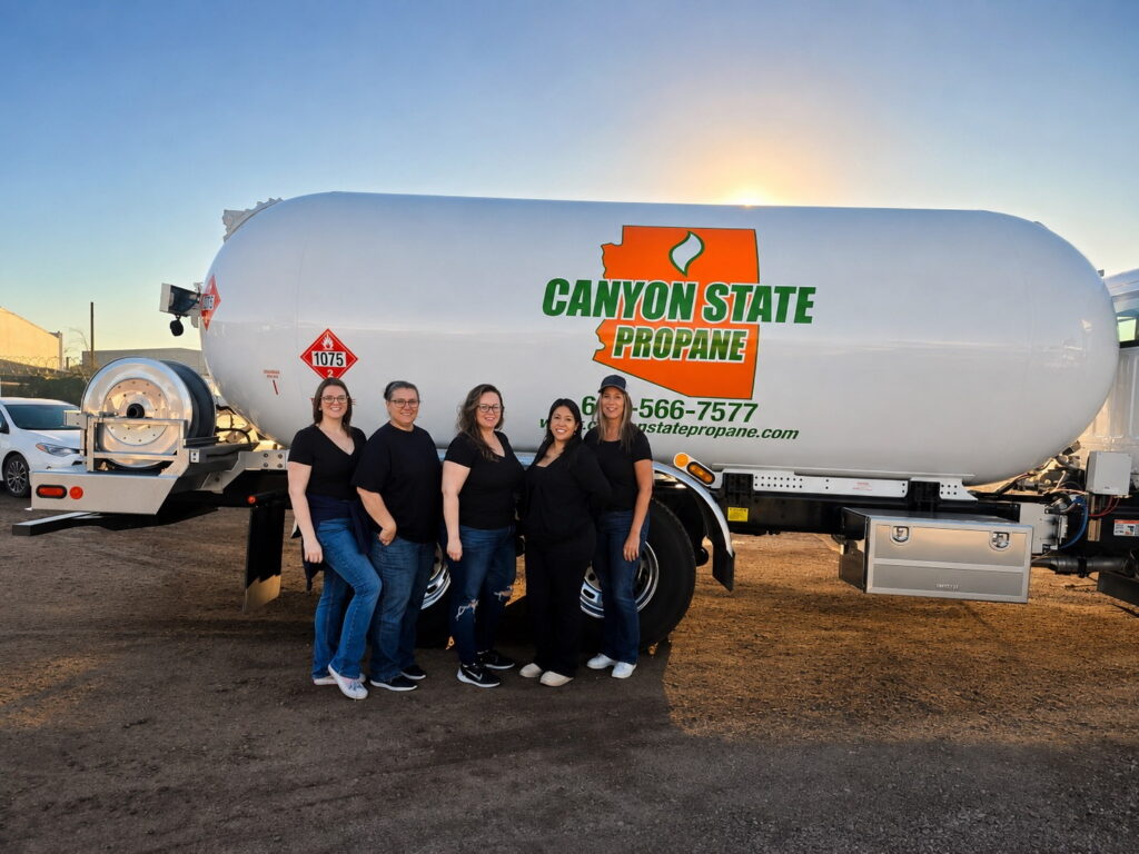 team members standing in front on propane truck